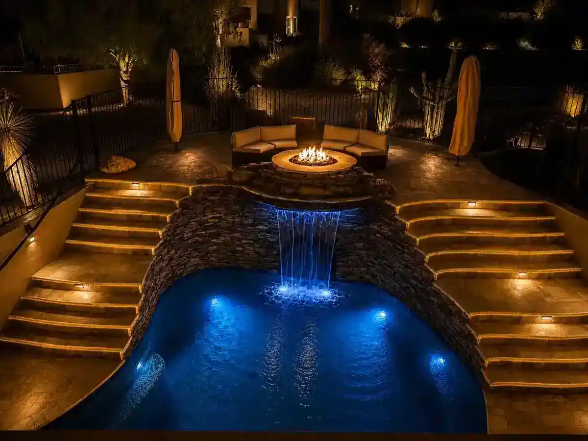 Twilight luxury backyard pool with desert landscaping in Phoenix